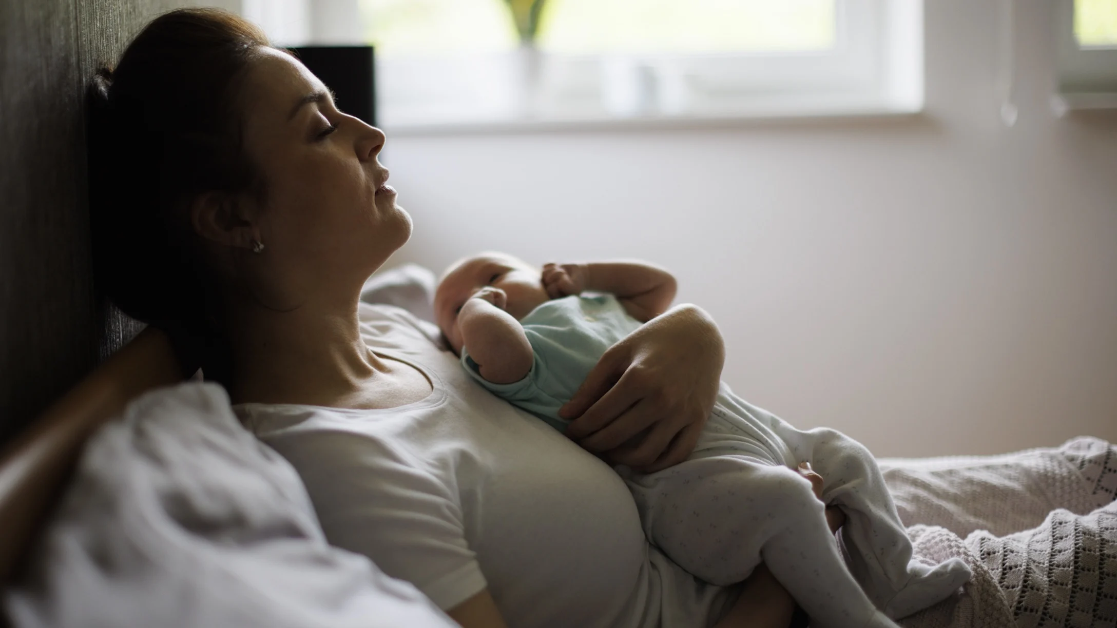 new-mom-resting-after-giving-birth-with-baby